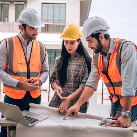 civil-engineer-construction-worker-architects-wearing-hardhats-safety-vests-are-working-together-construction-site-building-home-cooperation-teamwork-concept (1)