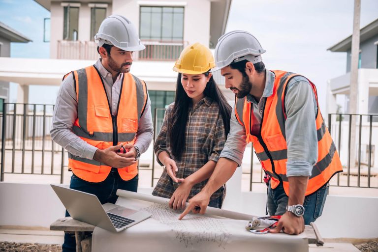 civil-engineer-construction-worker-architects-wearing-hardhats-safety-vests-are-working-together-construction-site-building-home-cooperation-teamwork-concept (1)
